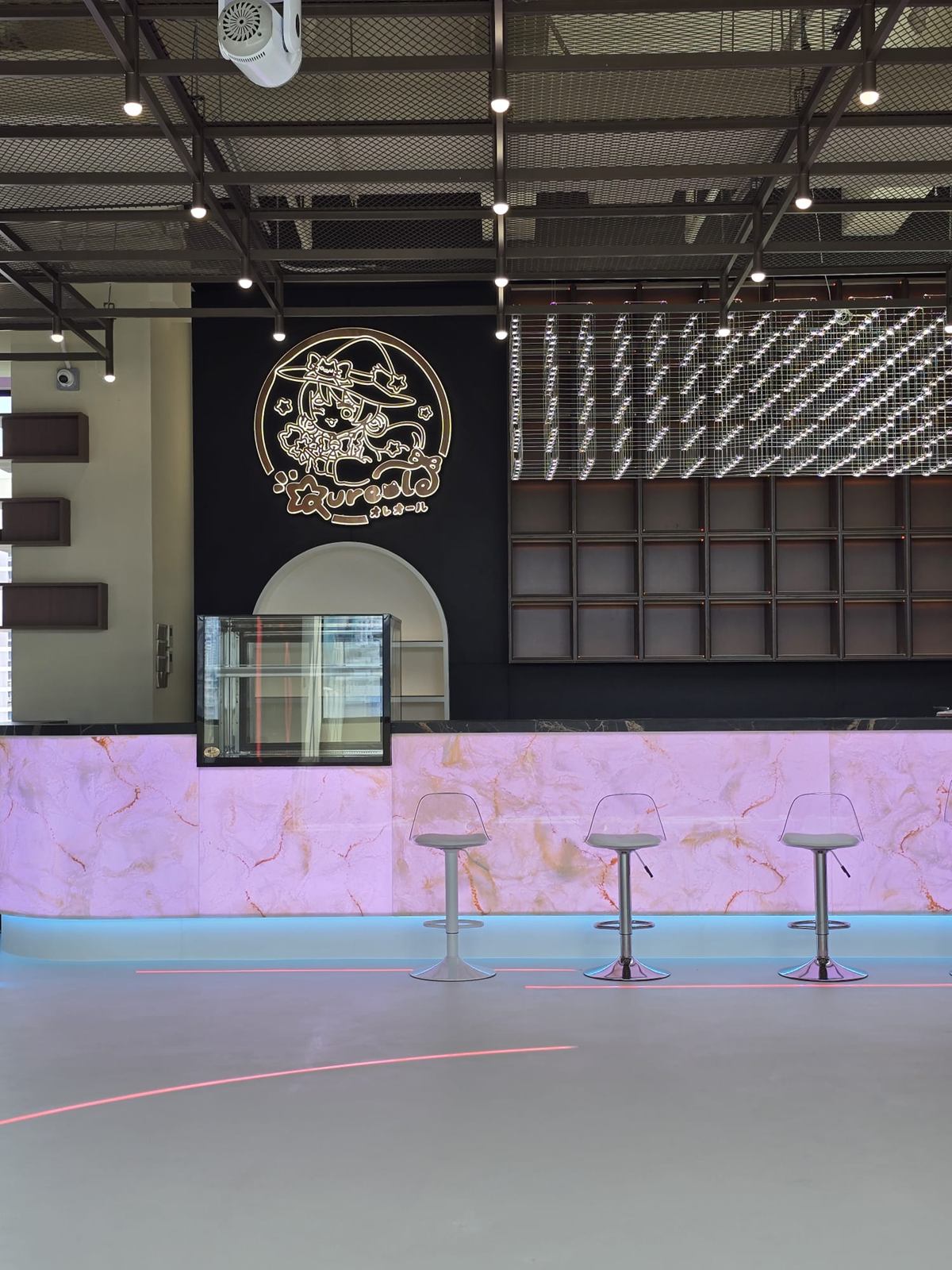 The same counter lit lilac-pink, with pink in-floor light lines.