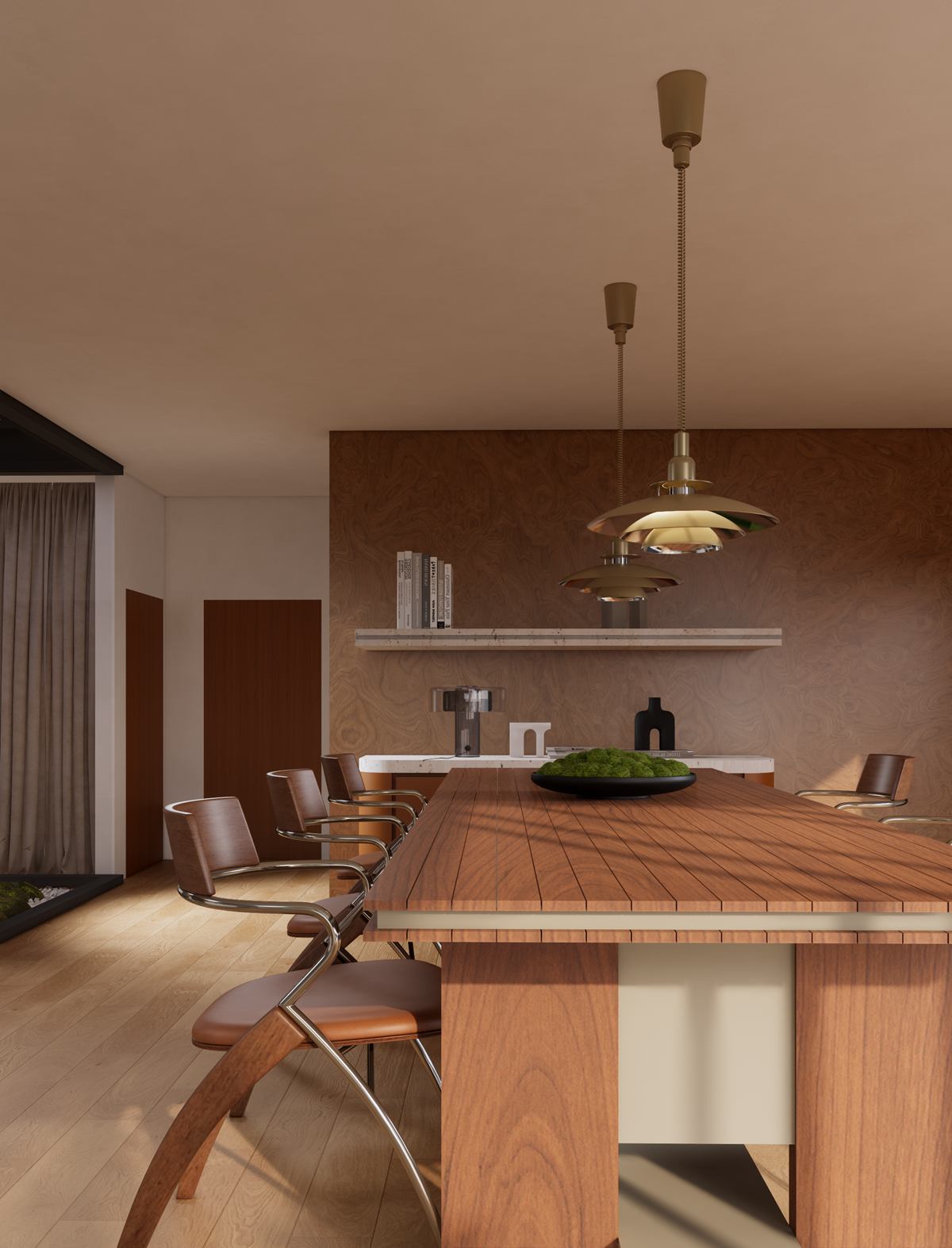 A timber dining table with curved chairs under brass pendants, against a warm plaster wall with a shelf.