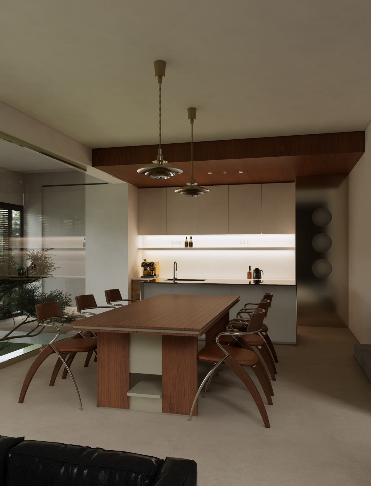 The dining table with sculpted timber chairs under two brass pendants.